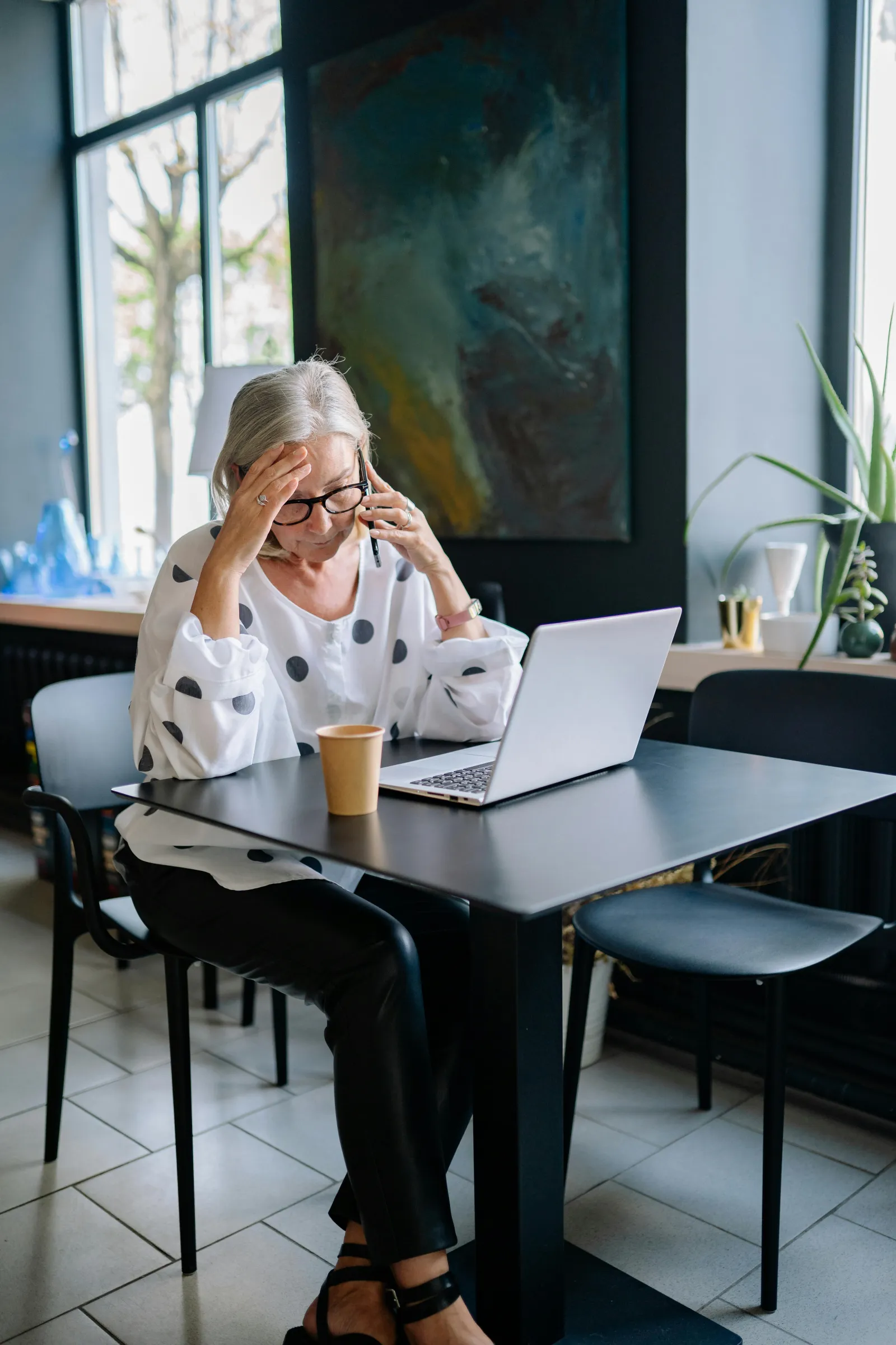 a person sitting at a table with a laptop