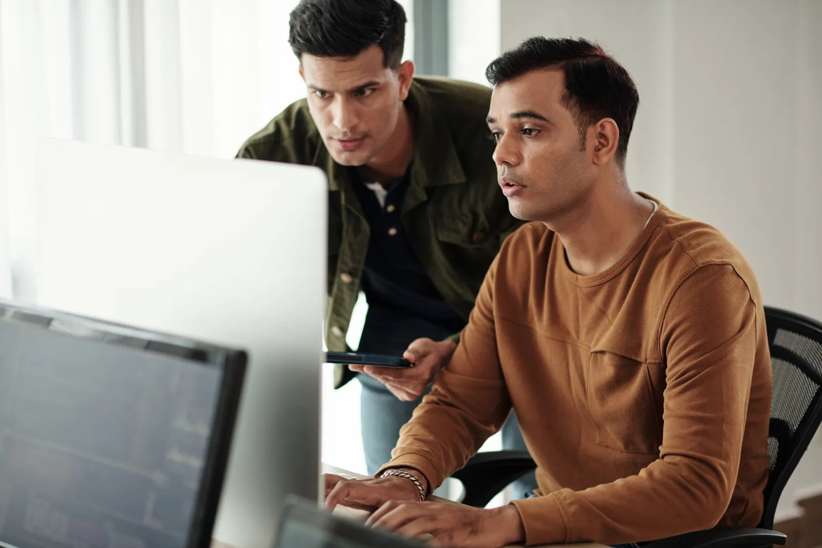 a few business people looking at a computer screen