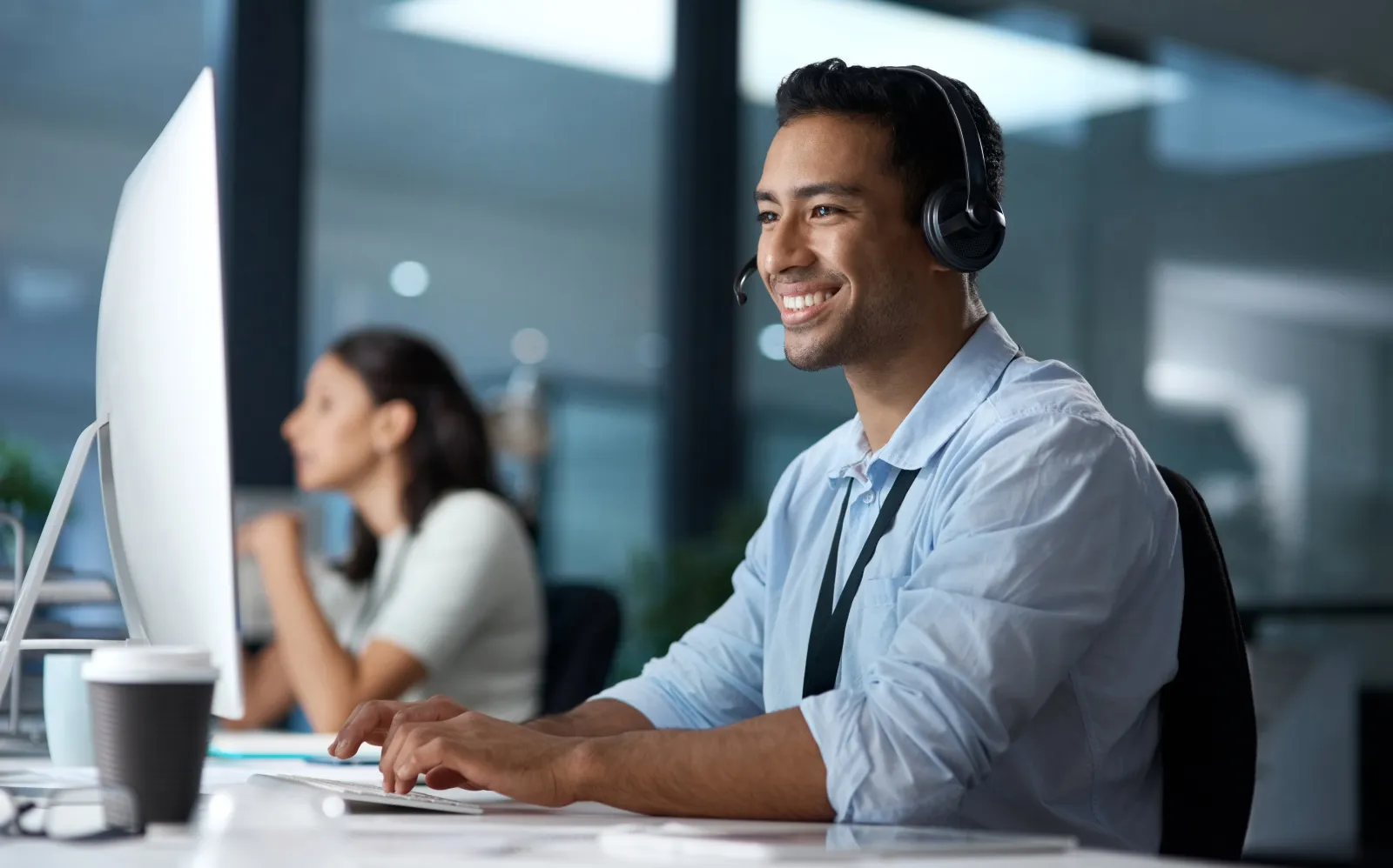 a person wearing headphones and sitting at a desk