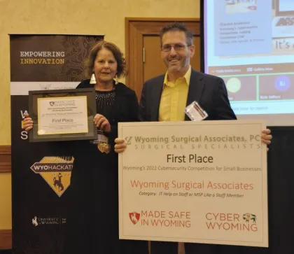 a man and a woman holding a sign