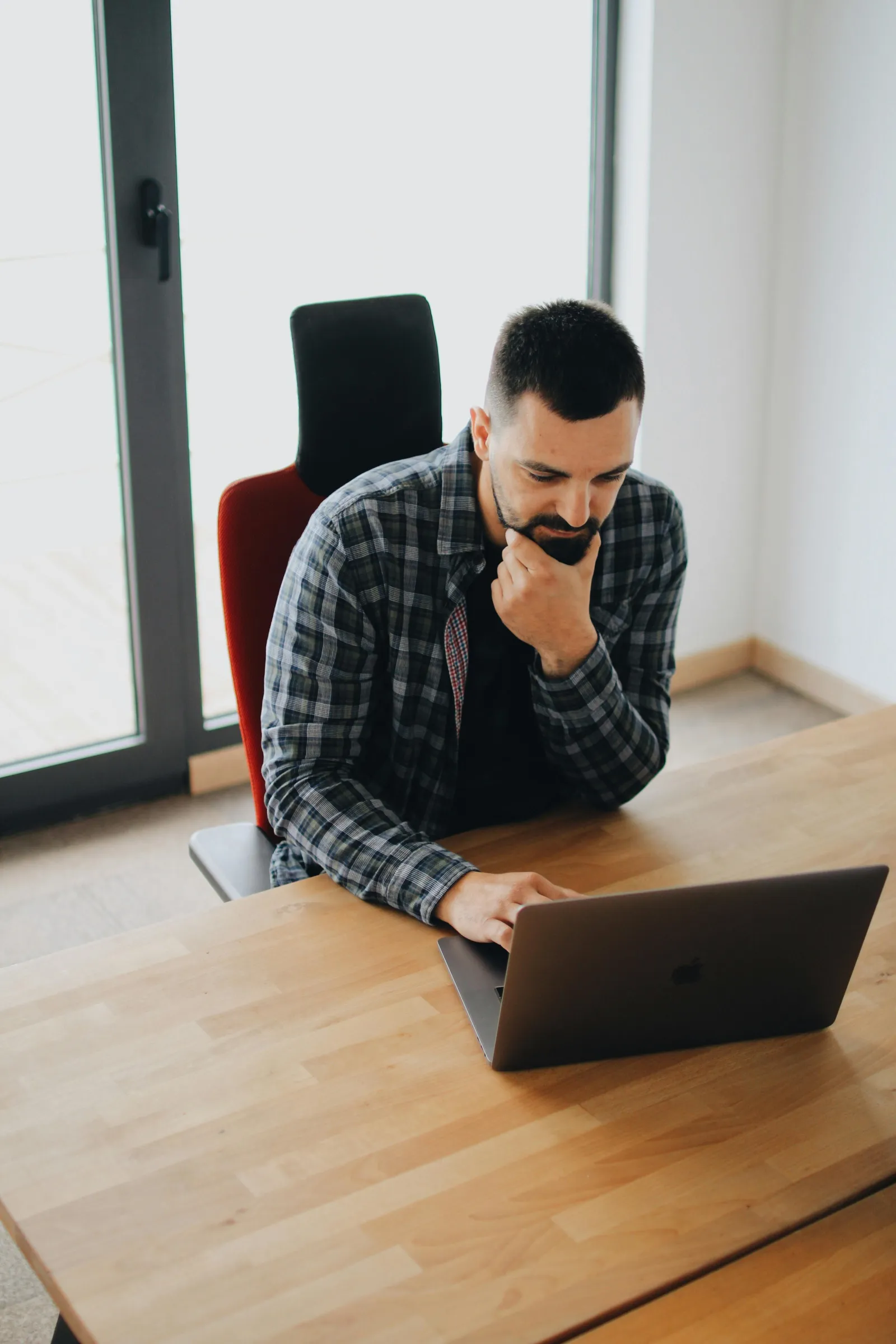 a man sitting at a table with a laptop