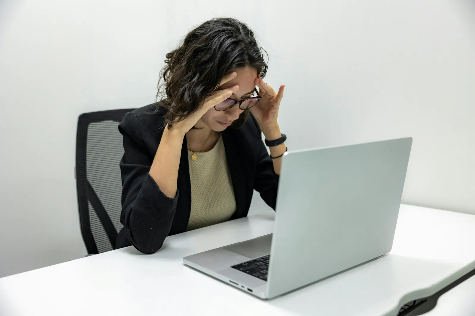 a woman sitting at a table with her hand on her face